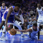 
              Philadelphia 76ers' Paul Reed, left, and Memphis Grizzlies' John Konchar chase a loose ball during the first half of an NBA basketball game, Thursday, Feb. 23, 2023, in Philadelphia. (AP Photo/Matt Slocum)
            