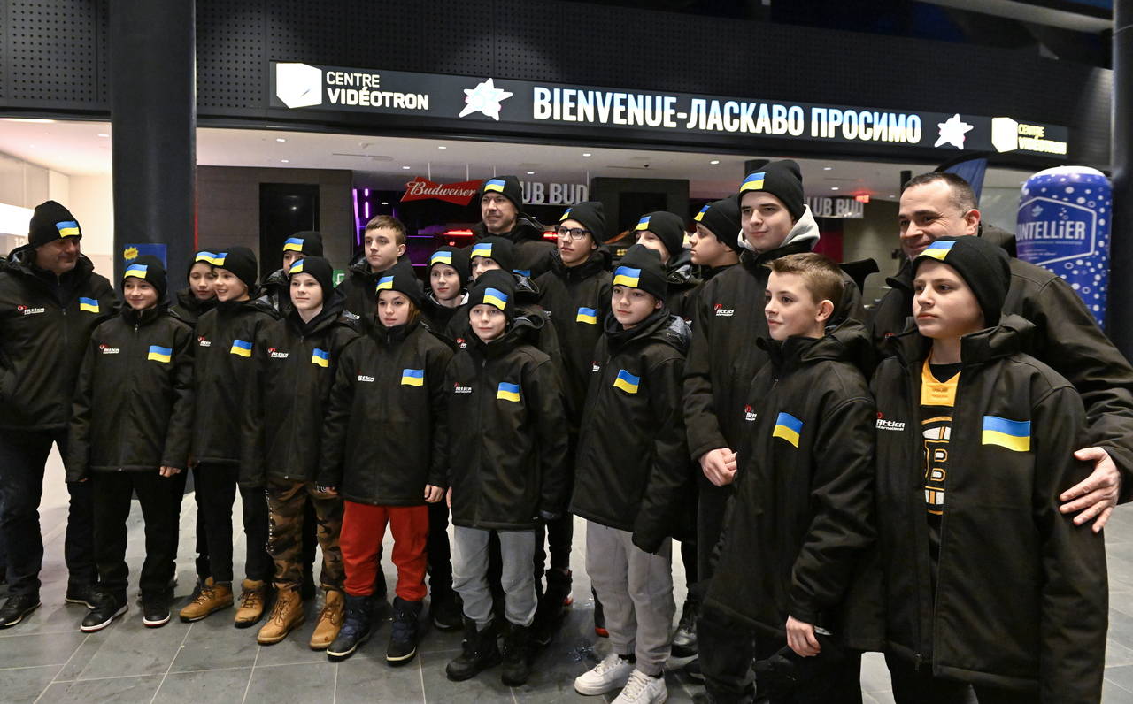 FILE -  Ukrainian peewee hockey team players and coaches pose for a group photo as they arrive, Wed...