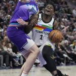 
              Minnesota Timberwolves guard Anthony Edwards (1) drives to the basket as Utah Jazz forward Kelly Olynyk (41) defends during the first half of an NBA basketball game Wednesday, Feb. 8, 2023, in Salt Lake City. (AP Photo/Rick Bowmer)
            
