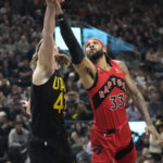 
              Toronto Raptors guard Gary Trent Jr. (33) goes to the basket as Utah Jazz forward Kelly Olynyk (41) defends during the first half of an NBA basketball game Wednesday, Feb. 1, 2023, in Salt Lake City. (AP Photo/Rick Bowmer)
            