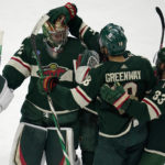 
              Minnesota Wild goaltender Filip Gustavsson, left, celebrates with teammates left wing Jordan Greenway, middle, and defenseman Alex Goligoski after defeating the New York Islanders 2-1 in a shootout of an NHL hockey game Tuesday, Feb. 28, 2023, in St. Paul, Minn. (AP Photo/Abbie Parr)
            