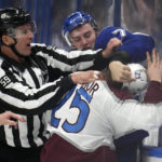 
              NHL linesman Steve Barton (59) attempts to break up a fight by Tampa Bay Lightning center Ross Colton (79) and Colorado Avalanche right wing Logan O'Connor (25) during the first period of an NHL hockey game Thursday, Feb. 9, 2023, in Tampa, Fla. (AP Photo/Chris O'Meara)
            
