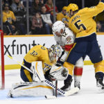 
              A shot by Florida Panthers center Nick Cousins gets past Nashville Predators goaltender Kevin Lankinen (32) for a goal as defenseman Kevin Gravel (5) defends against center Eric Staal (12) during the first period of an NHL hockey game Saturday, Feb.18, 2023, in Nashville, Tenn. (AP Photo/Mark Zaleski)
            