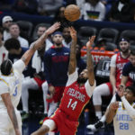 
              New Orleans Pelicans forward Brandon Ingram (14)m shoots between Los Angeles Lakers forward Anthony Davis (3) and forward Rui Hachimura (28) in the second half of an NBA basketball game in New Orleans, Saturday, Feb. 4, 2023. The Pelicans won 121-136. (AP Photo/Gerald Herbert)
            