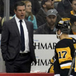 
              Pittsburgh Penguins head coach Mike Sullivan talks with right wing Bryan Rust (17) as they take on the New York Islanders during the second period of an NHL hockey game in Pittsburgh, Monday, Feb. 20, 2023. (AP Photo/Matt Freed)
            