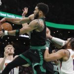 
              Boston Celtics' Jayson Tatum, center, battles Phoenix Suns' Ish Wainright (12) for a rebound during the second half of an NBA basketball game, Friday, Feb. 3, 2023, in Boston. (AP Photo/Michael Dwyer)
            