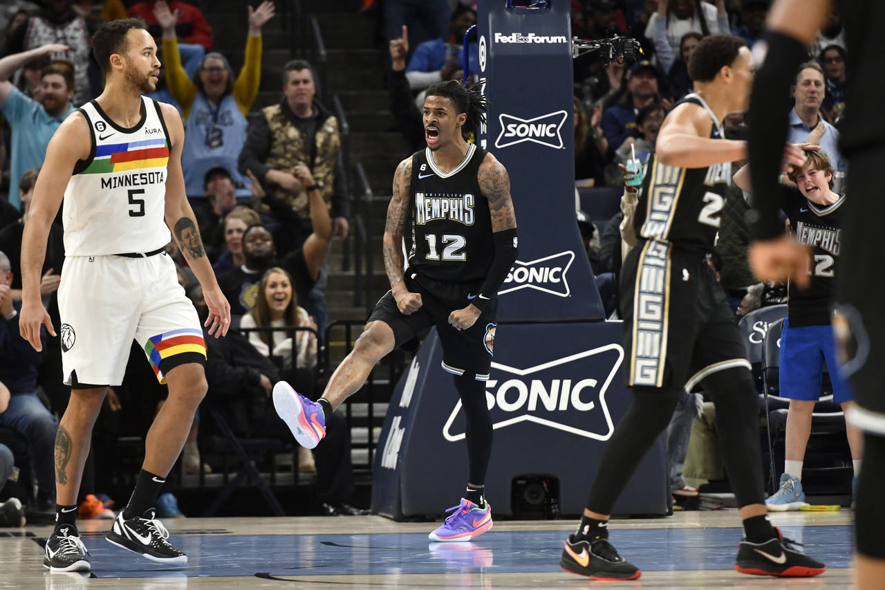 Memphis Grizzlies guard Ja Morant (12) reacts in the second half of an NBA basketball game against ...