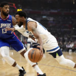 
              Minnesota Timberwolves guard Mike Conley, right, drives against Los Angeles Clippers forward Paul George (13) during the first half of an NBA basketball game Tuesday, Feb. 28, 2023, in Los Angeles. (AP Photo/Marcio Jose Sanchez)
            