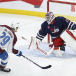 
              Winnipeg Jets goaltender Connor Hellebuyck (37) gives up a goal to Colorado Avalanche's Nathan MacKinnon (29) during the first period of an NHL hockey game Friday, Feb. 24, 2023, in Winnipeg, Manitoba. (John Woods/The Canadian Press via AP)
            
