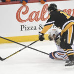 
              Pittsburgh Penguins right wing Josh Archibald (15) and Edmonton Oilers defenseman Evan Bouchard (2) go for the puck during the first period of an NHL hockey game, Thursday, Feb. 23, 2023, in Pittsburgh. (AP Photo/Philip G. Pavely)
            
