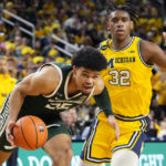
              Michigan State forward Malik Hall (25) drives to the basket as Michigan forward Tarris Reed Jr. (32) defends during the first half of an NCAA college basketball game, Saturday, Feb. 18, 2023, in Ann Arbor, Mich. (AP Photo/Carlos Osorio)
            