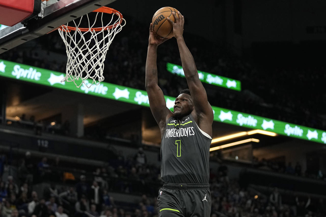 Minnesota Timberwolves guard Anthony Edwards (1) goes up for a dunk during the first half of an NBA...