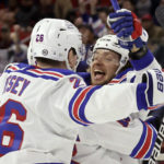 
              New York Rangers left wing Artemi Panarin (10) celebrates his second goal of the night against the Carolina Hurricanes with left wing Jimmy Vesey (26), during the third period of an NHL hockey game Saturday, Feb. 11, 2023, in Raleigh, N.C. (AP Photo/Chris Seward)
            