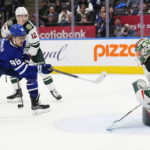 
              Toronto Maple Leafs' William Nylander (88) scores against Minnesota Wild goaltender Filip Gustavsson (32) during overtime NHL hockey game action in Toronto, Friday, Feb. 24, 2023. (Frank Gunn/The Canadian Press via AP)
            