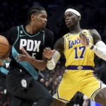 
              Portland Trail Blazers forward Cam Reddish, left, drives to the basket against Los Angeles Lakers guard Dennis Schroder, right, during the first half of an NBA basketball game in Portland, Ore., Monday, Feb. 13, 2023. (AP Photo/Steve Dykes)
            