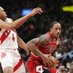 
              Chicago Bulls forward DeMar DeRozan (11) drives past Toronto Raptors forward Scottie Barnes (4) during the first half of an NBA basketball game Tuesday, Feb. 28, 2023, in Toronto. (Frank Gunn/The Canadian Press via AP)
            