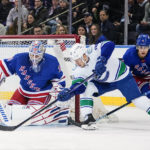 
              New York Rangers goaltender Igor Shesterkin (31) stops a shot on goal by Vancouver Canucks' Curtis Lazar, center, as Braden Schneider (4) defends during the second period of an NHL hockey game Wednesday, Feb. 8, 2023, in New York. (AP Photo/Frank Franklin II)
            