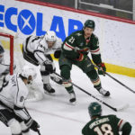 
              Minnesota Wild right wing Brandon Duhaime (21) looks to pass the puck as Los Angeles Kings defenseman Mikey Anderson reaches to block the puck next to goalie Pheonix Copley during the first period of an NHL hockey game Tuesday, Feb. 21, 2023, in St. Paul, Minn. (AP Photo/Craig Lassig)
            