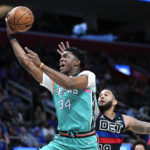 
              San Antonio Spurs forward Stanley Johnson (34) drives on Detroit Pistons guard Cory Joseph (18) in the second half of an NBA basketball game in Detroit, Friday, Feb. 10, 2023. (AP Photo/Paul Sancya)
            