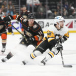 
              Pittsburgh Penguins' Mark Friedman (52) moves the puck as he is followed by Anaheim Ducks' Trevor Zegras (11) during the first period of an NHL hockey game Friday, Feb. 10, 2023, in Anaheim, Calif. (AP Photo/Jae C. Hong)
            