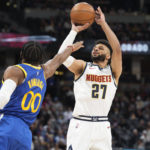 
              Denver Nuggets guard Jamal Murray (27) looks to shoot over Golden State Warriors forward Jonathan Kuminga (00) in the first half of an NBA basketball game Thursday, Feb. 2, 2023, in Denver. (AP Photo/David Zalubowski)
            