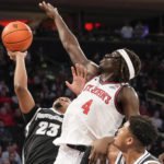
              St. John's forward O'Mar Stanley (4) blocks the shot of Providence forward Bryce Hopkins (23) during the first half of an NCAA college basketball game, Saturday, Feb. 11, 2023 in New York. (AP Photo/Bryan Woolston)
            