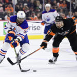 
              Edmonton Oilers' Evander Kane, left, tries to keep the puck from Philadelphia Flyers' Kevin Hayes during the third period of an NHL hockey game, Thursday, Feb. 9, 2023, in Philadelphia. (AP Photo/Derik Hamilton)
            