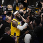 
              Los Angeles Lakers forward LeBron James is surrounded by cameras after scoring to pass Kareem Abdul-Jabbar to become the NBA's all-time leading scorer during the second half of an NBA basketball game against the Oklahoma City Thunder Tuesday, Feb. 7, 2023, in Los Angeles. (AP Photo/Marcio Jose Sanchez)
            