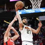
              Denver Nuggets guard Jamal Murray (27) drives to the basket past Houston Rockets center Alperen Sengun during the first half of an NBA basketball game Tuesday, Feb. 28, 2023, in Houston. (AP Photo/Eric Christian Smith)
            