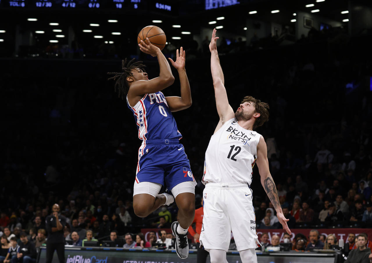 Philadelphia 76ers' Tyrese Maxey (0) shoots against Brooklyn Nets' Joe Harris (12) during the first...
