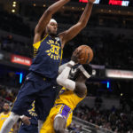 
              Indiana Pacers center Myles Turner (33) defends Los Angeles Lakers guard Dennis Schroder (17) during the first half of an NBA basketball game in Indianapolis, Thursday, Feb. 2, 2023. (AP Photo/Michael Conroy)
            