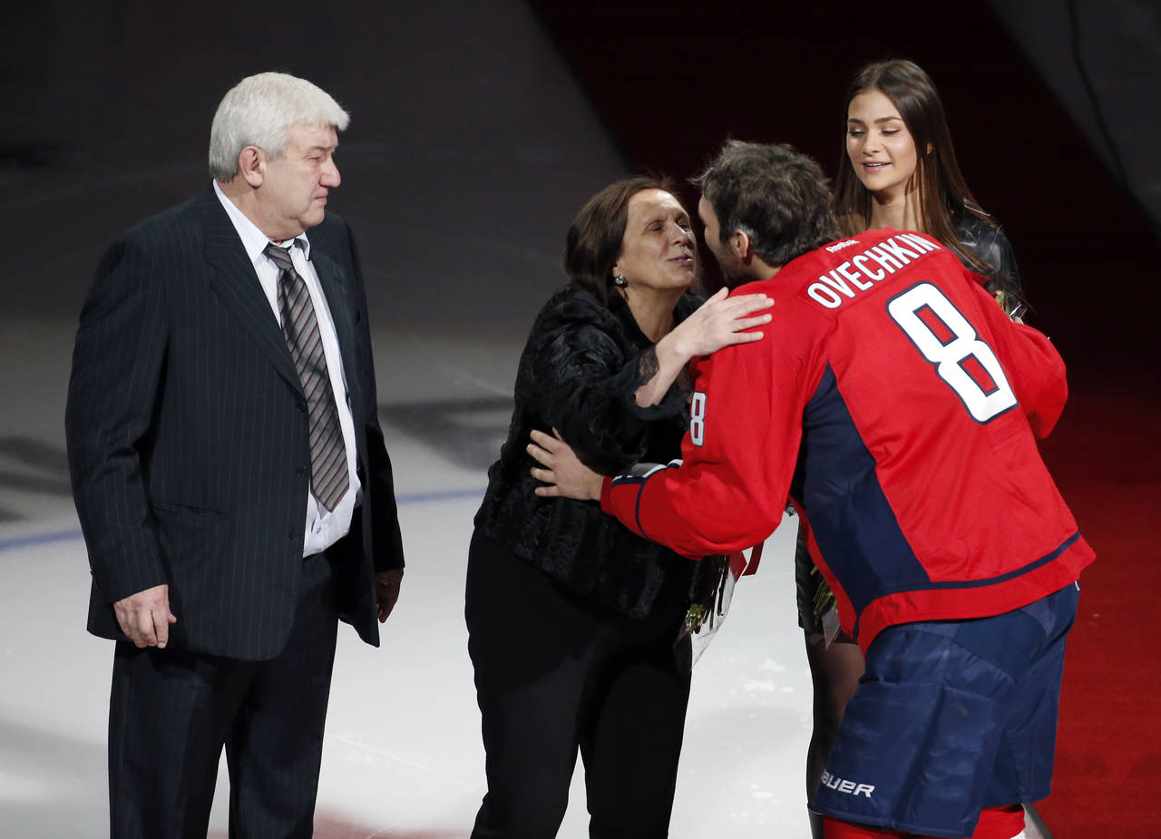 FILE - Mikhail Ovechkin, stands as his wife receives a kiss from their son, Washington Capitals lef...