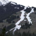 
              FILE - Thin strips of snow create the course, at left, of an alpine ski, men's World Cup giant slalom competition, in Adelboden, Switzerland, Friday, Jan. 6, 2023, the day before the race. Mother Nature and global warming are having just as much say about when and where to hold ski races these days as the International Ski Federation.  (AP Photo/Gabriele Facciotti, File)
            