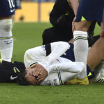 
              Tottenham's Rodrigo Bentancur receives medical attention during the English Premier League soccer match between Leicester City and Tottenham Hotspur at King Power stadium in Leicester, England, Saturday, Feb. 11, 2023. (AP Photo/Rui Vieira)
            