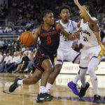 
              Houston's Marcus Sasser (0) drives against East Carolina's Jaden Walker (21) during the second half of an NCAA college basketball game in Greenville, N.C., Saturday, Feb. 25, 2023. (AP Photo/Ben McKeown)
            