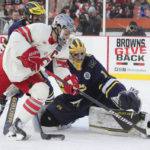 
              Ohio State's Jake Wise (28) tries to get his stick on the puck as Michigan goalie Erik Portillo, right, is able to block it away from the goal for a save in the first period during the "Faceoff On The Lake" college hockey game Saturday, Feb. 18, 2023, in Cleveland. (John Kuntz/Cleveland.com via AP)
            