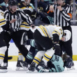 
              Boston Bruins left wing Brad Marchand (63) and Seattle Kraken right wing Oliver Bjorkstrand (22) fight during the third period of an NHL hockey game Thursday, Feb. 23, 2023, in Seattle. The Bruins won 6-5. (AP Photo/John Froschauer)
            
