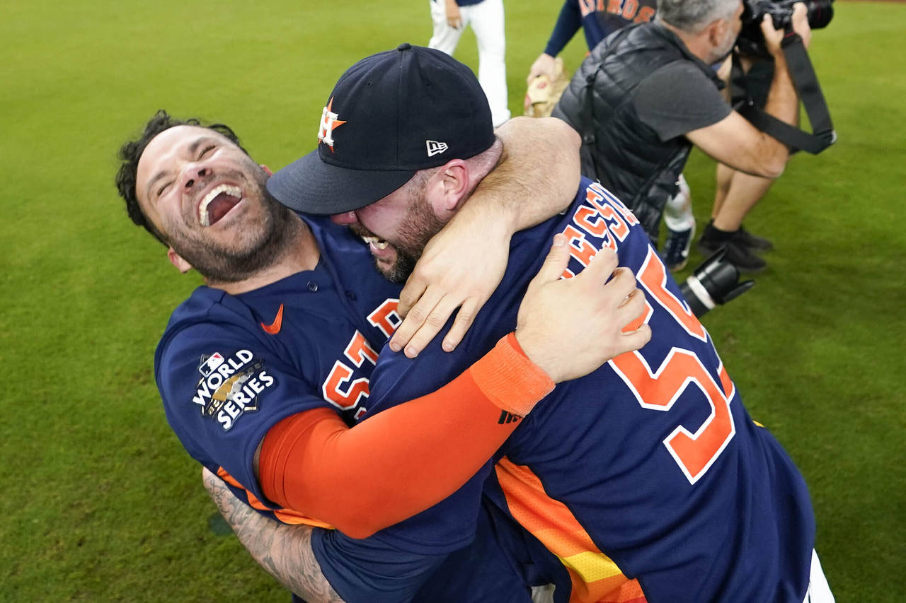 FILE - Houston Astros' Jose Altuve, left, embraces relief pitcher Ryan Pressly as they celebrate th...