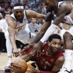 
              Cleveland Cavaliers guard Donovan Mitchell (45) gets possession of the ball against Denver Nuggets forward Bruce Brown (11) and forward Jeff Green during the first half of an NBA basketball game Thursday, Feb. 23, 2023, in Cleveland. (AP Photo/Ron Schwane)
            