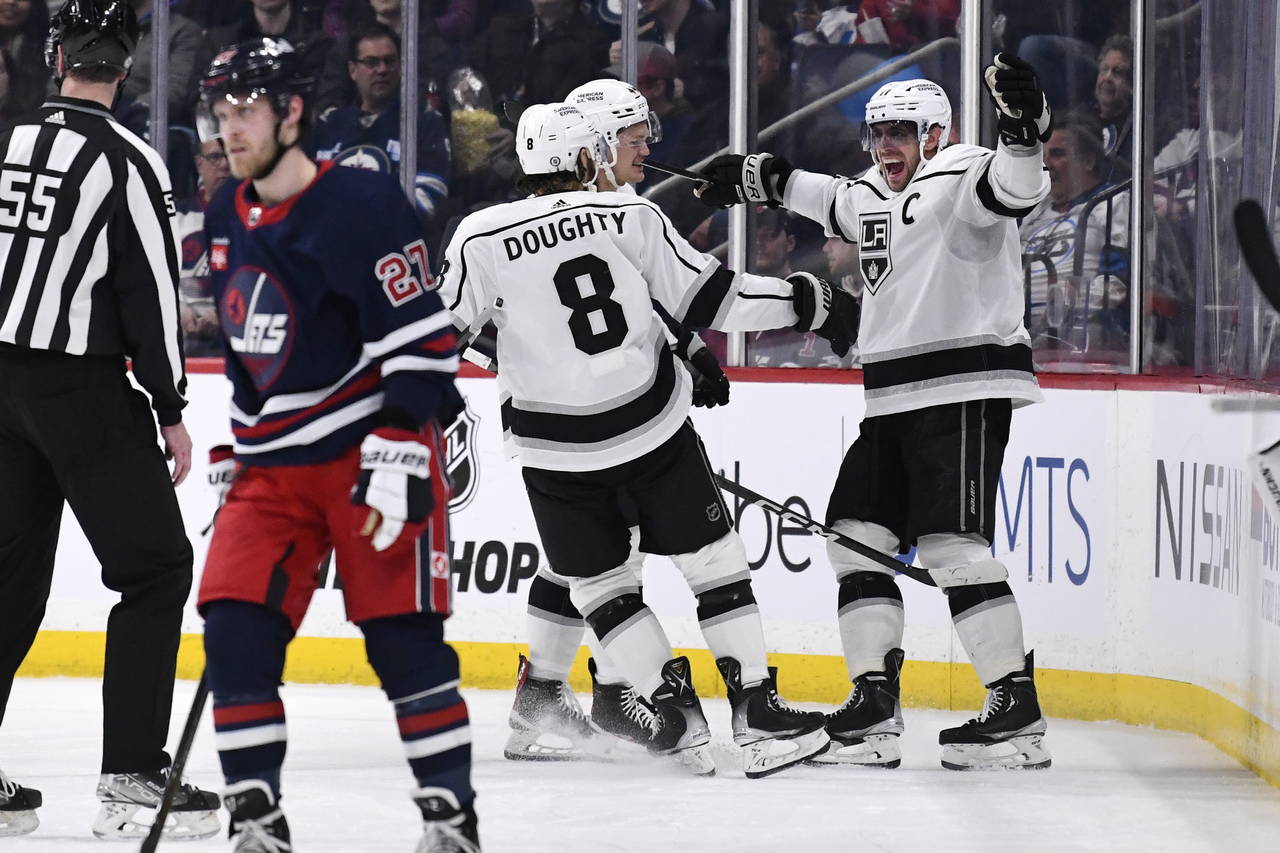 Los Angeles Kings' Anze Kopitar celebrates his goal against the Winnipeg Jets with Drew Doughty (8)...