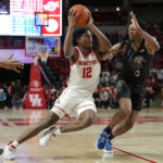 
              Houston guard Tramon Mark (12) drives around Memphis guard Elijah McCadden (0) during the second half of an NCAA college basketball game, Sunday, Feb. 19, 2023, in Houston. (AP Photo/Kevin M. Cox)
            