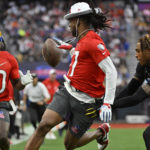 
              AFC wide receiver Davante Adams of the Las Vegas Raiders, center, pitches the ball back to AFC wide receiver Tyreek Hill (10) of the Miami Dolphins as NFC cornerback Jalen Ramsey of the Los Angles Rams defends during the flag football event at the NFL Pro Bowl, Sunday, Feb. 5, 2023, in Las Vegas. (AP Photo/David Becker)
            