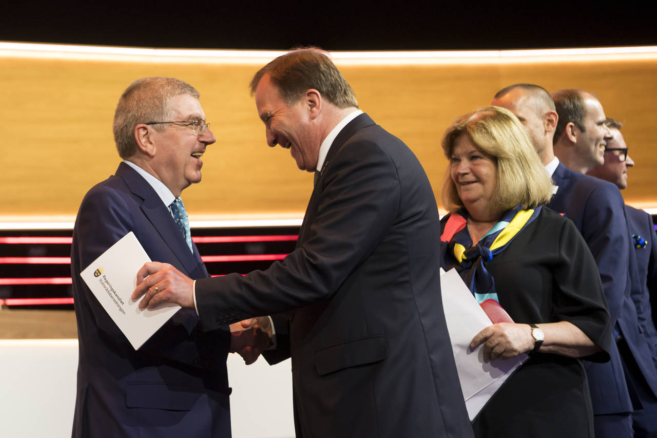 FILE - International Olympic Committee, IOC, President Thomas Bach from Germany, shakes hands with ...