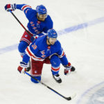 
              New York Rangers' K'Andre Miller (79) helps Chris Kreider (20) after Kreider was hurt during the third period of an NHL hockey game against the Vancouver Canucks Wednesday, Feb. 8, 2023, in New York. The Rangers won 4-3. (AP Photo/Frank Franklin II)
            