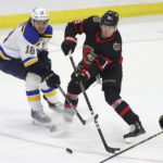 
              Ottawa Senators Tim Stutzle (18) passes the puck while St. Louis Blues Robert Thomas (18) and Ivan Barbashev (49) defend during second-period NHL hockey game action in Ottawa, Ontario, Sunday, Feb. 19, 2023. (Patrick Doyle/The Canadian Press via AP)
            
