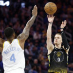 
              Golden State Warriors guard Donte DiVincenzo (0) shoots against Los Angeles Lakers guard Lonnie Walker IV (4) during the first half of an NBA basketball game in San Francisco, Saturday, Feb. 11, 2023. (AP Photo/Jed Jacobsohn)
            
