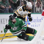
              Dallas Stars defenseman Jani Hakanpaa (2) is pulled down to the ice by Boston Bruins left wing Nick Foligno (17) in the second period of an NHL hockey game, Tuesday, Feb. 14, 2023, in Dallas. Foigno was issued a penalty for holding on the play. (AP Photo/Tony Gutierrez)
            