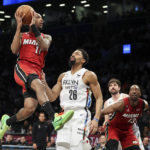 
              Miami Heat guard Jamaree Bouyea (11) drives to the basket against Brooklyn Nets guard Spencer Dinwiddie (26) as Heat center Bam Adebayo (13) and Nets forward Joe Harris watch during the first half of an NBA basketball game Wednesday, Feb. 15, 2023, in New York. (AP Photo/Jessie Alcheh)
            