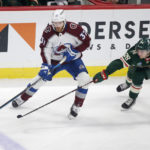 
              Colorado Avalanche left wing J.T. Compher (37) controls the puck in front of Minnesota Wild center Connor Dewar (26) in the first period of an NHL hockey game Wednesday, Feb. 15, 2023, in St. Paul, Minn. (AP Photo/Andy Clayton-King)
            