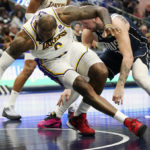 
              Los Angeles Lakers forward LeBron James, left, reaches for the ball against Dallas Mavericks guard Luka Doncic, right, during the second half of an NBA basketball game in Dallas, Sunday, Feb. 26, 2023. (AP Photo/LM Otero)
            